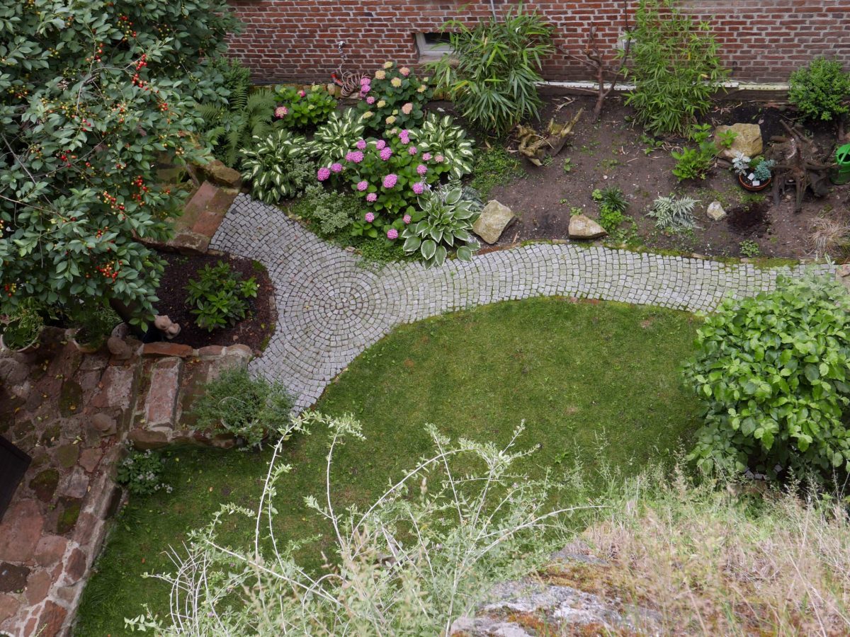 looking-down-to-a-garden-with-brick-path-2026-03-26-11-39-14-utc