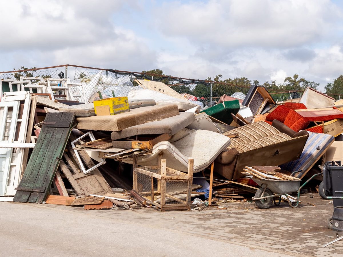 Recycling dump with trash of broken window and door frames, furniture, sofas, chairs and more