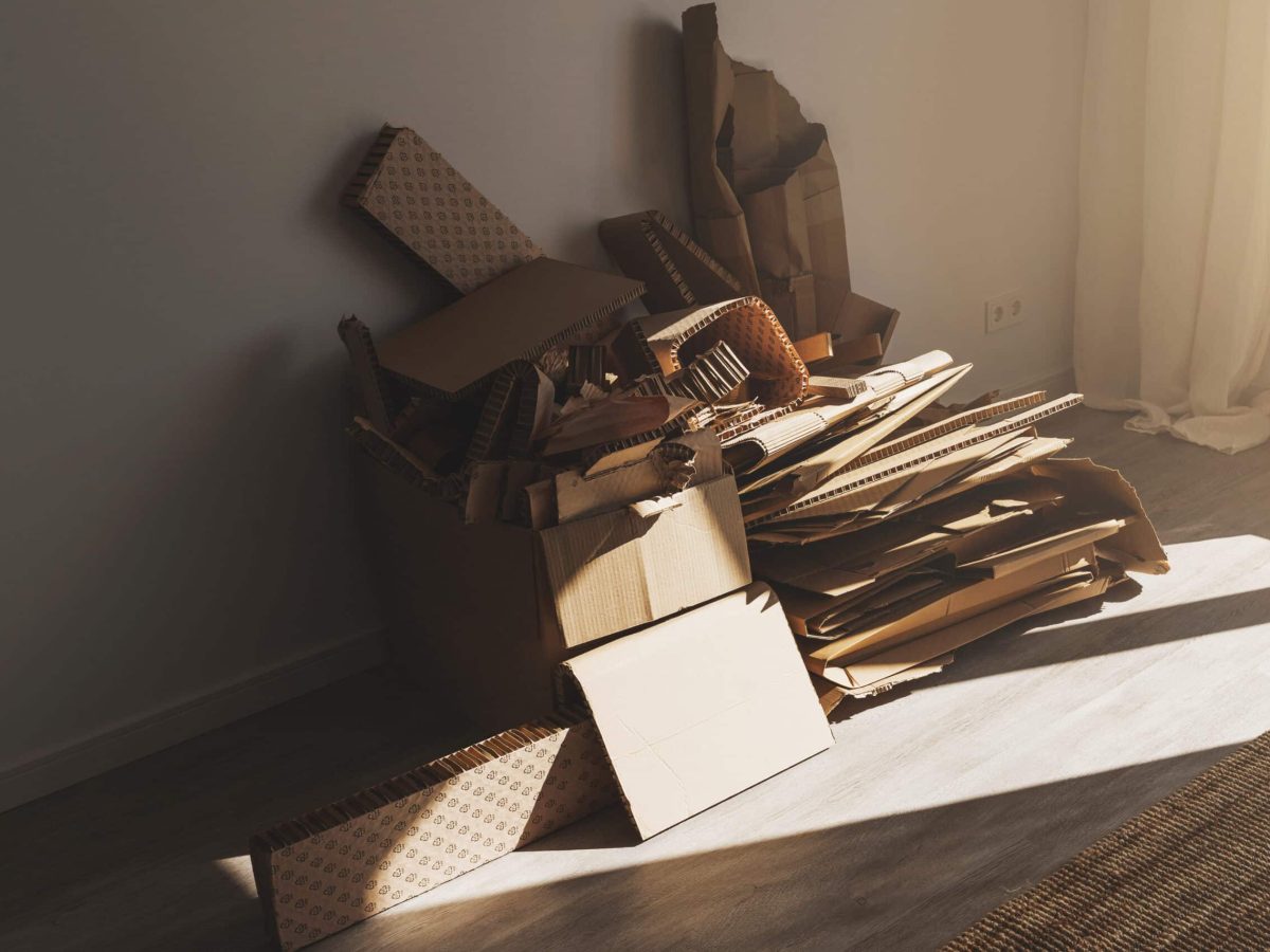 Stack of Cardboard Waste at home. Concepts of Paper Recycling and Waste Sorting.